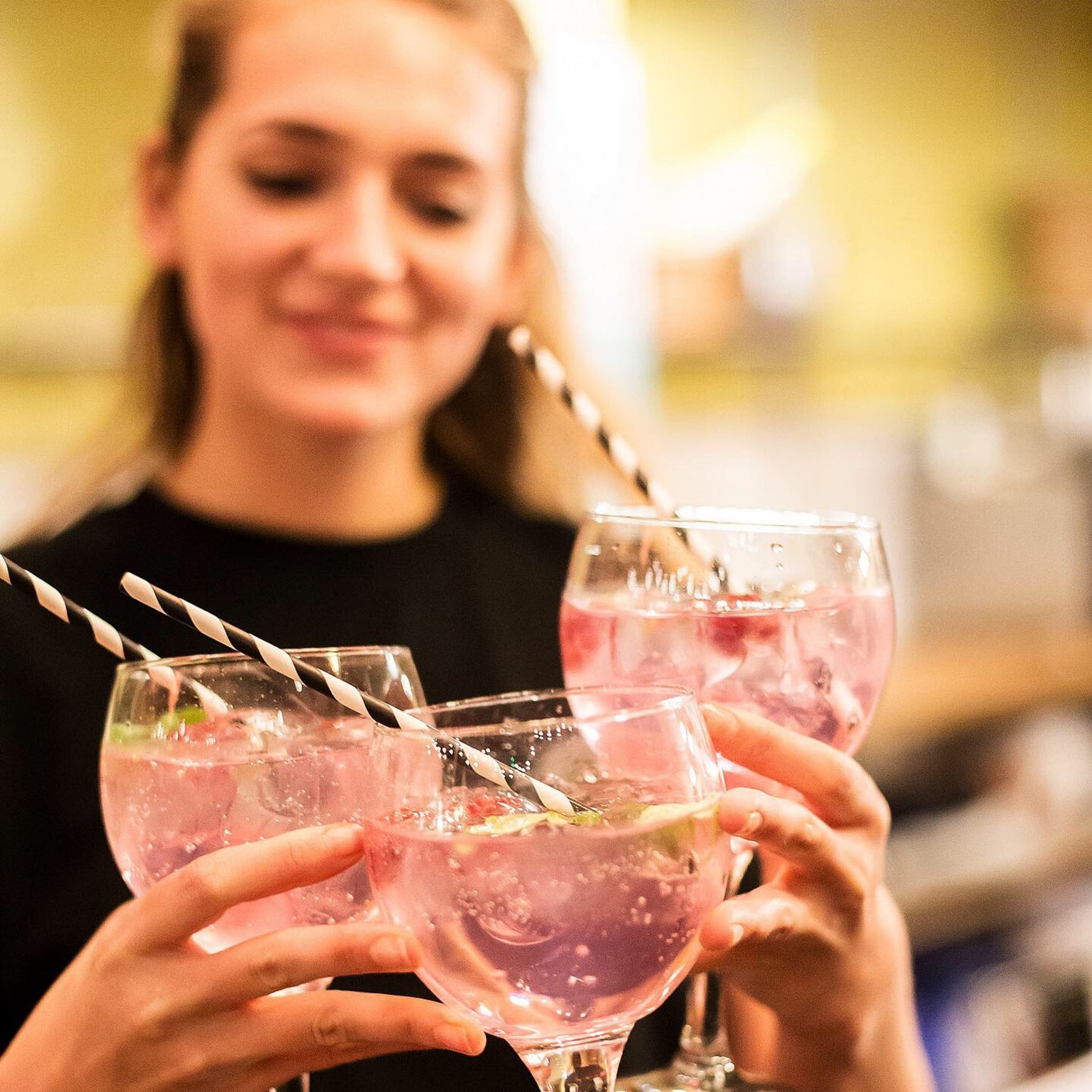 Jim and Tonic bartender serving three gin and tonics at the bar in London